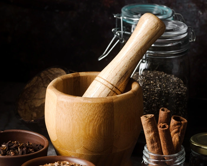 Wooden mortar and pestle with Ayurvedic spices